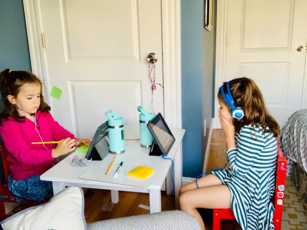 The author's 6-year-old twin daughters, pictured on their first day of remote first grade. (Courtesy)