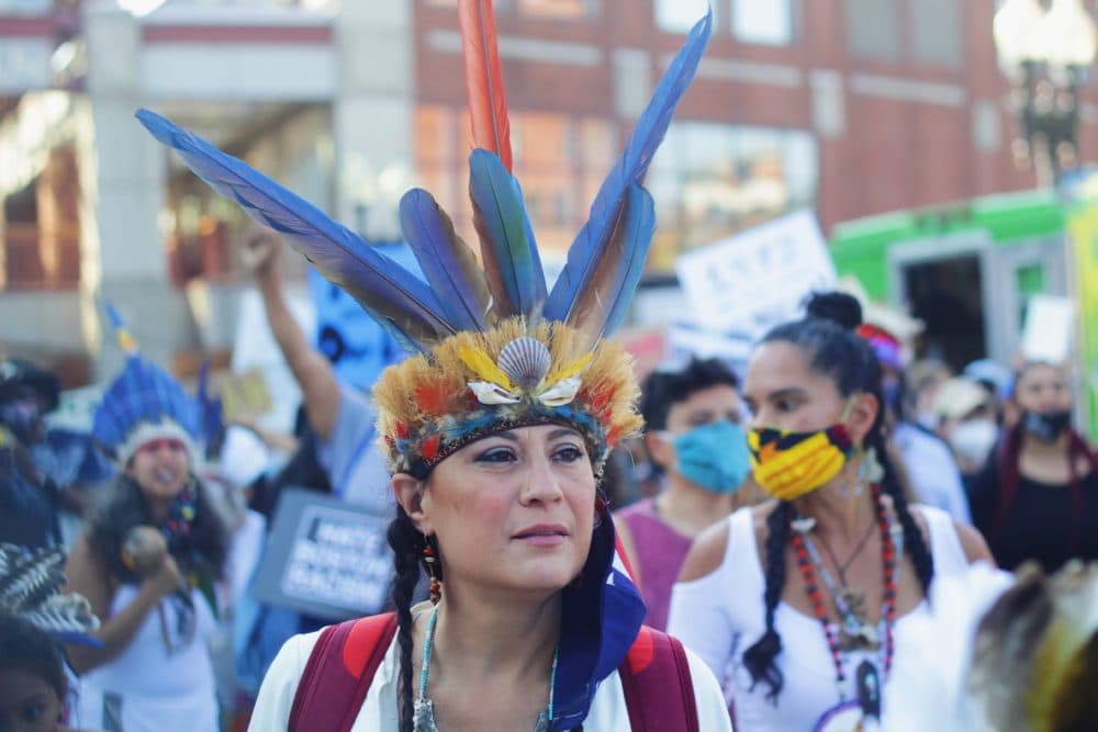 Chali'Naru Dones, a Taino woman who lives in Newton, is pictured at Saturday's rally. (Quincy Walters/WBUR)
