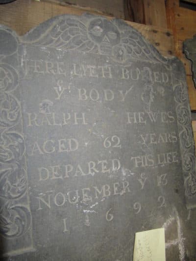One of the misplaced gravestones, inscribed with the name Ralph Hewes, is shown. (Courtesy City of Boston)