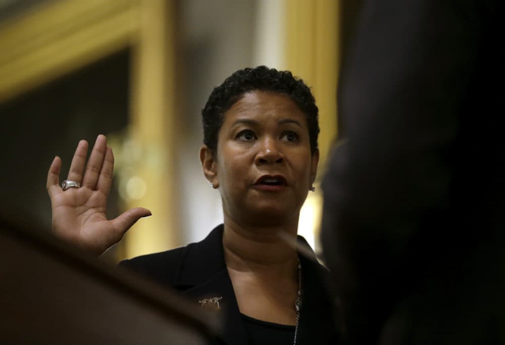 Massachusetts Supreme Judicial Court justice Kimberly Budd, left, takes a ceremonial oath from Mass. Gov. Charlie Baker, right, in 2016 during a ceremony at Faneuil Hall in Boston. (Steven Senne/AP)