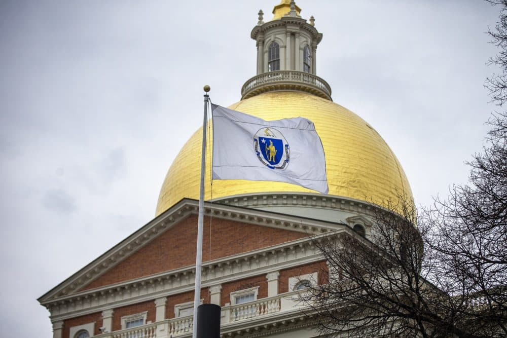 The Massachusetts State House and Flag. (Jesse Costa/WBUR)