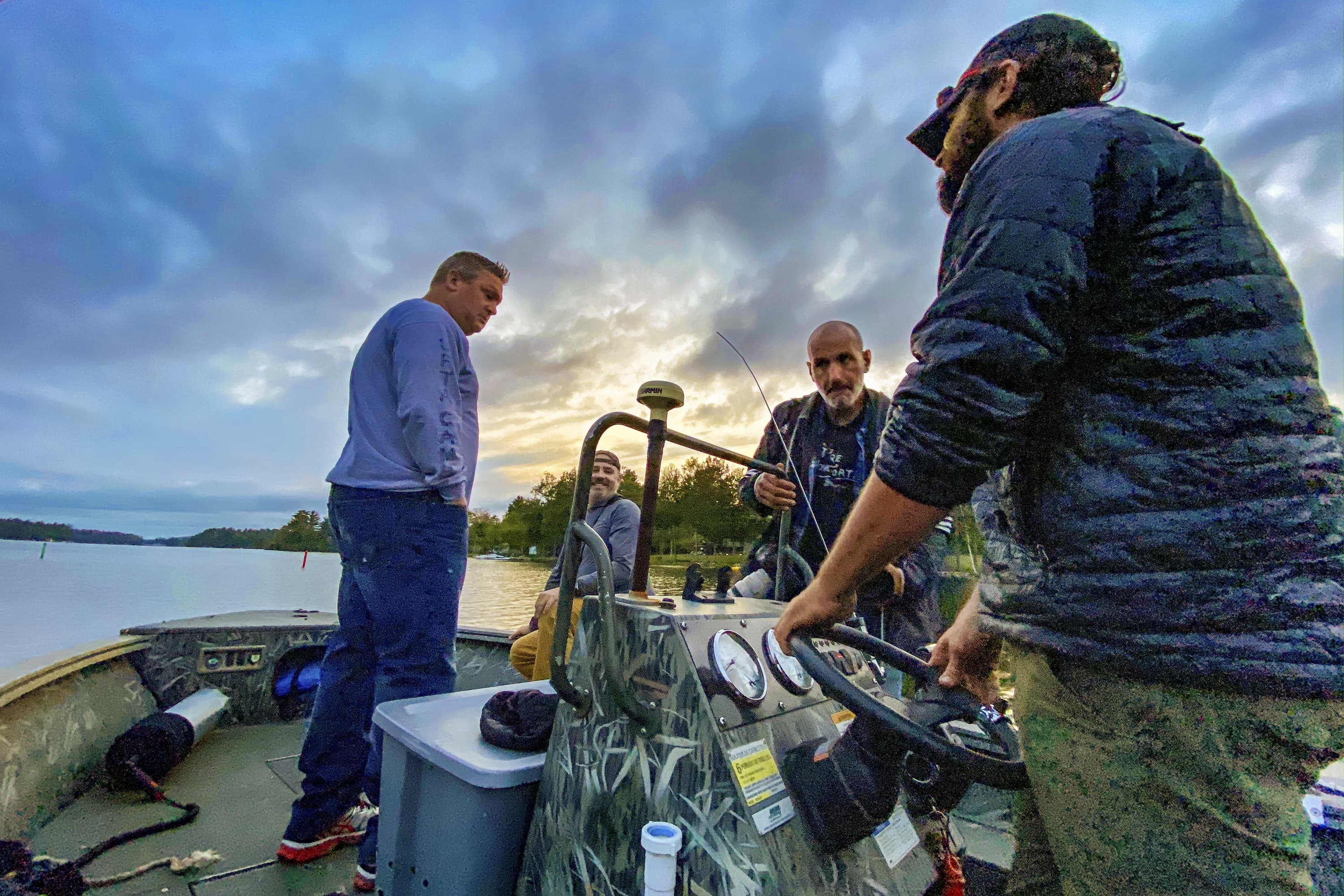 WBUR photographer Jesse Costa (second to right) heads out with the team for a loon capture on Woodbury Pond in Litchfield, ME. (Miriam Wasser/WBUR)