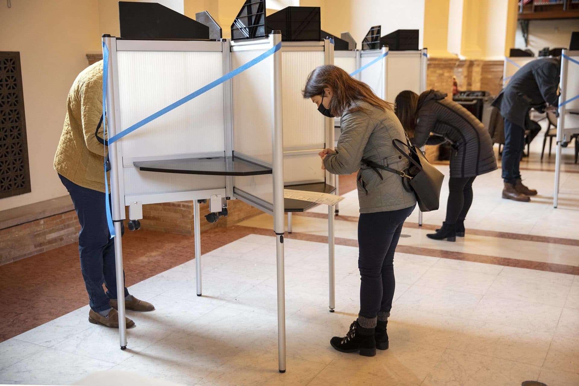 Voters fill the booths at the Boston Public Library. (Robin Lubbock/WBUR)