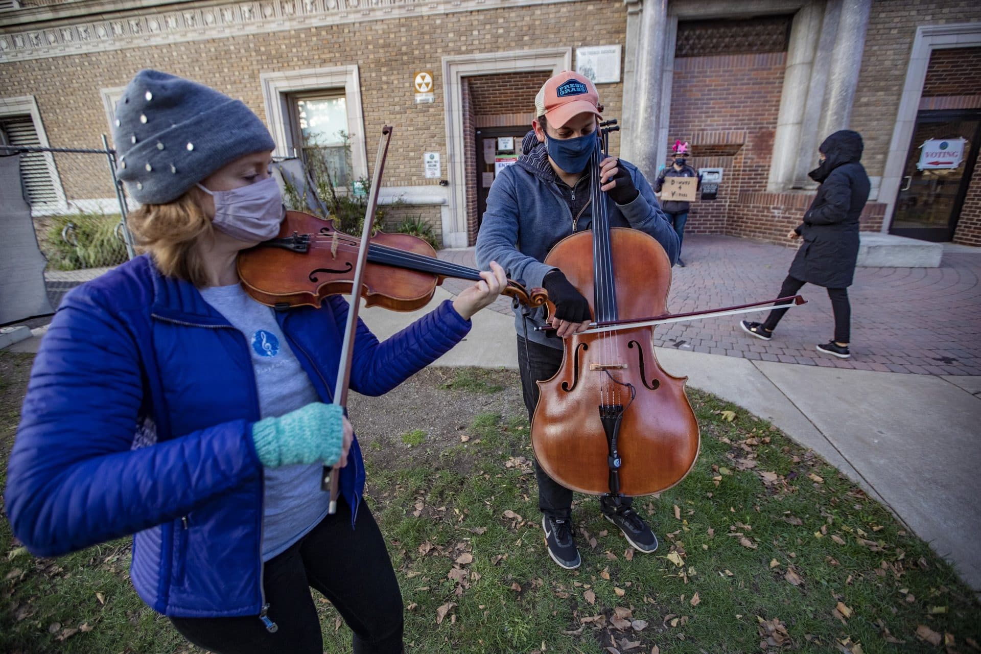 Hanneke Cassel and Mike Block, of Play for the Vote, play a duet in front of the Somerville Public Library for voters on Election Day. (Jesse Costa/WBUR)