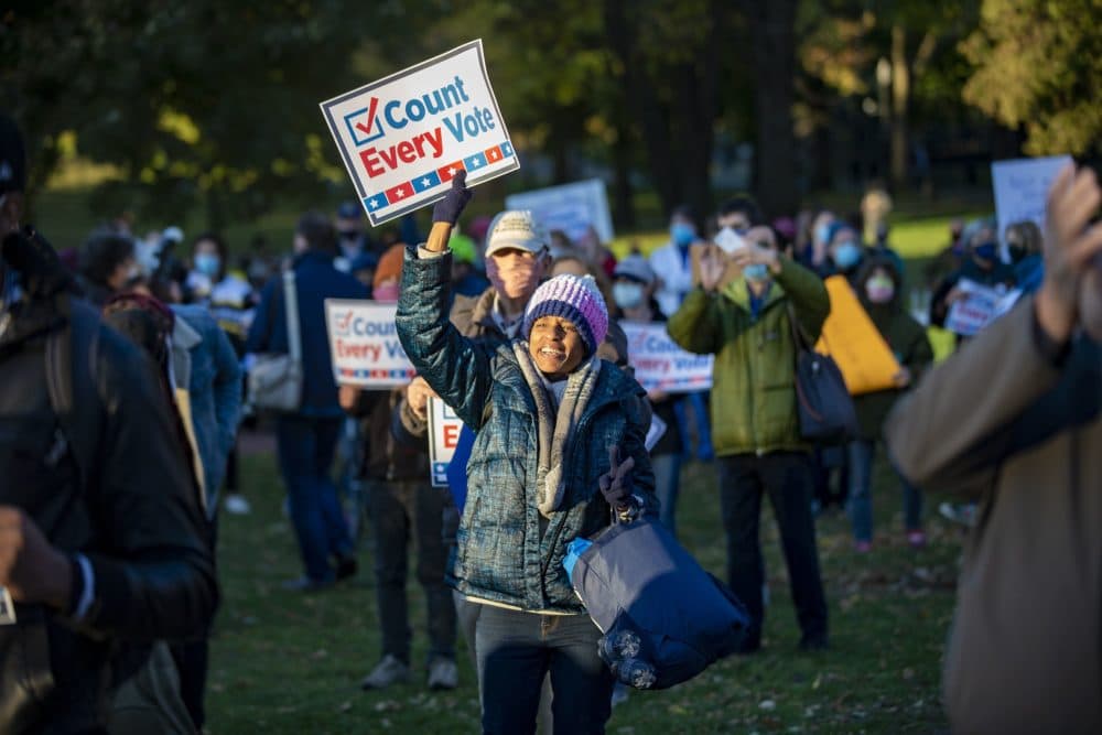 Karen Louise Gonsalves cheers as U.S. Senator Ed Markey takes the stage to speak during the Count Every Vote Rally at the Parkman Bandstand in the Boston Common. (Jesse Costa/WBUR)
