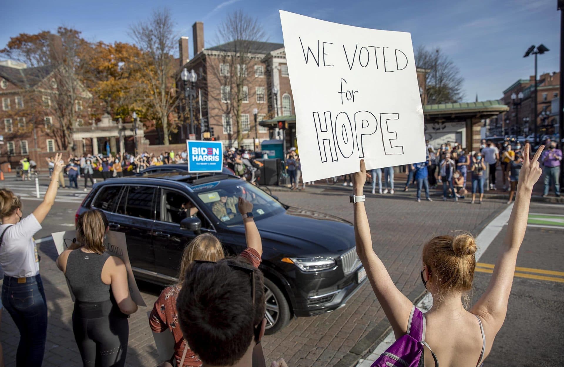 A woman holds up a sign saying &quot;We Voted For Hope&quot; as the crowd in Harvard Square celebrates Biden's election. (Robin Lubbock/WBUR)