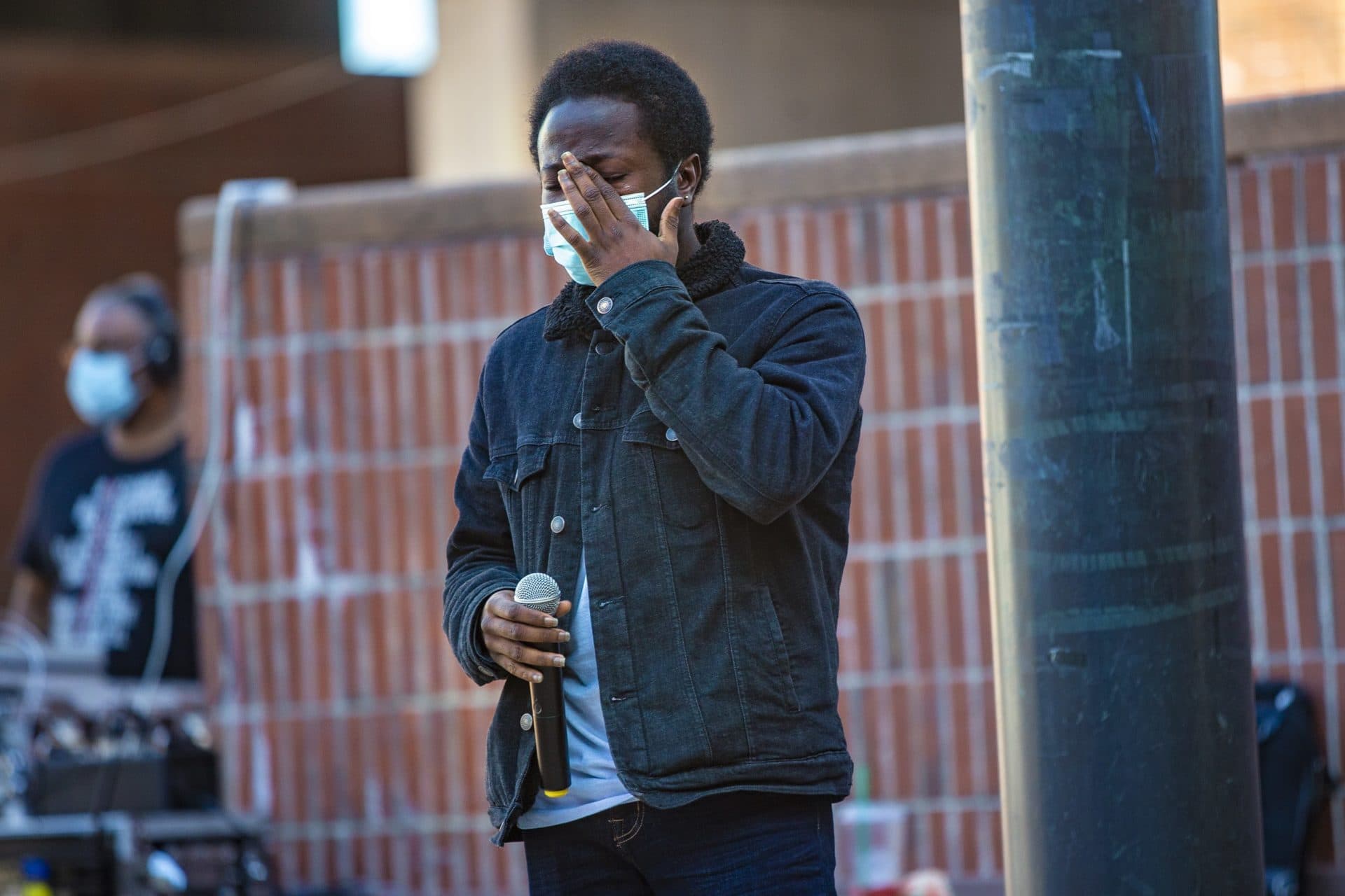 Ashawn Dabney-Small, the first 18-year-old to run for the Boston City Council, wipes tears from his eye while he speaks at the What this Win Means for Black Lives rally at City Hall Plaza. (Jesse Costa/WBUR)
