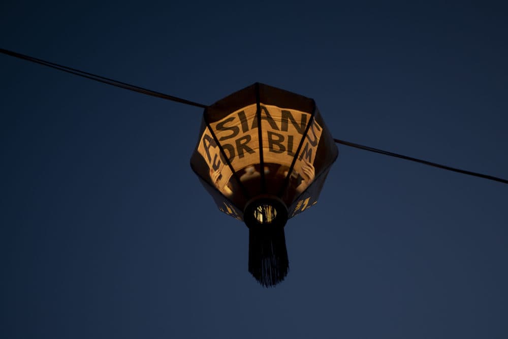 The phrase &quot;Asians for BLM&quot; is displayed on a lantern in Yu-Wen Wu's installation &quot;Lantern Stories&quot; at the Rose Kennedy Greenway in Chinatown. (Jesse Costa/WBUR)
