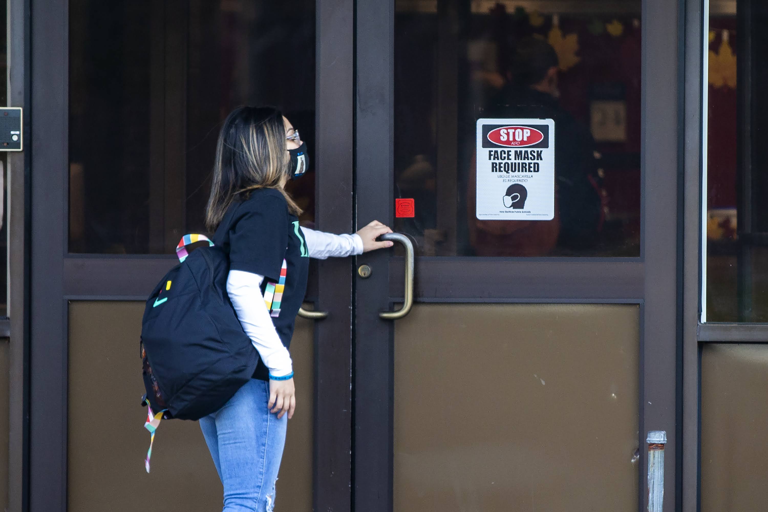 A student walks into New Bedford High School in the early morning. (Jesse Costa/WBUR)