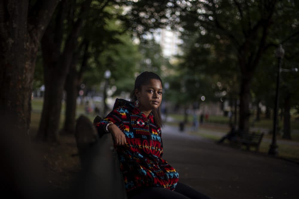 Alyssa Harris, a member of the Mashpee Wampanoag Tribe, sits for a portrait in a park in Boston on Oct. 2, 2020. (David Goldman/AP)