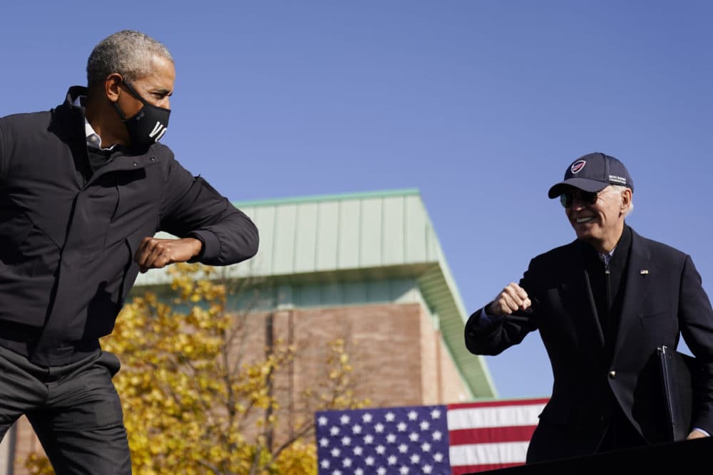 In this Oct. 31, 2020 photo, Democratic presidential candidate former Vice President Joe Biden, right, and former President Barack Obama greet each other with an air elbow bump, at the conclusion of rally at Northwestern High School in Flint, Mich. (Andrew Harnik/AP)