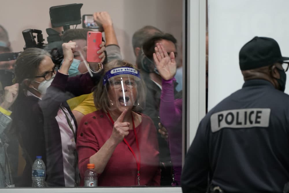 Pro-Trump protesters yell as they look through the windows of the central counting board as police were helping to keep others from entering due to overcrowding on Wednesday, Nov. 4, 2020, in Detroit. (Carlos Osorio/AP)