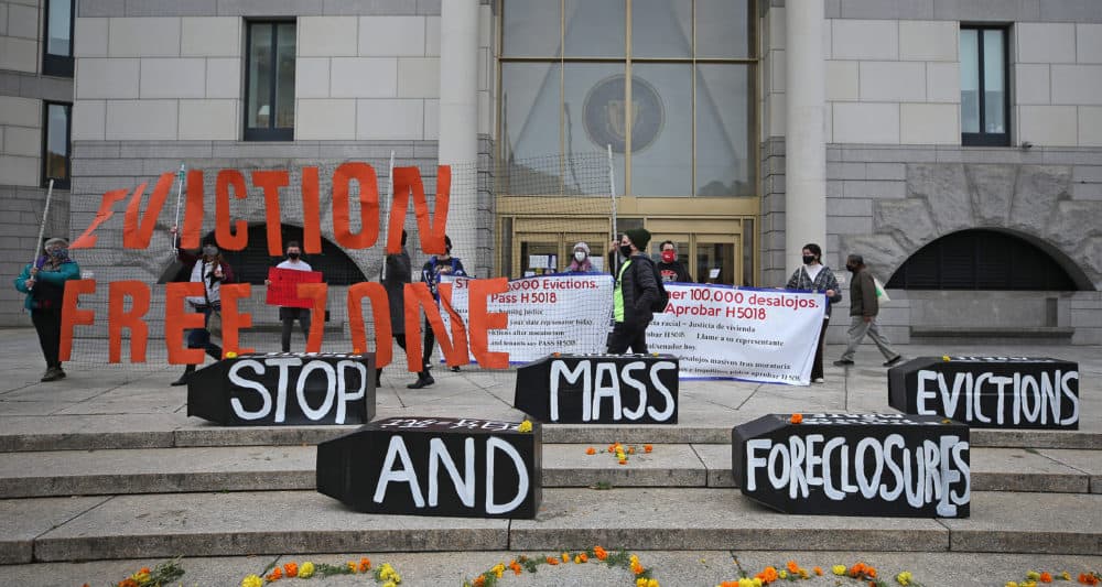 Demonstrators display signs calling for an end to evictions and foreclosures during a rally at Boston Housing Court outside the Edward W. Brooke Courthouse in Boston on Oct. 29, 2020. (David L. Ryan/The Boston Globe via Getty Images)
