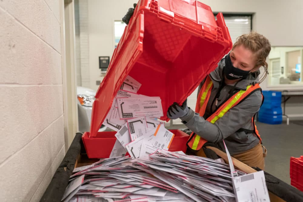 Election worker Sarah Sladek empties a box of submitted ballots at the Multnomah County Elections Office on November 2, 2020 in Portland, Oregon. (Nathan Howard/Getty Images)