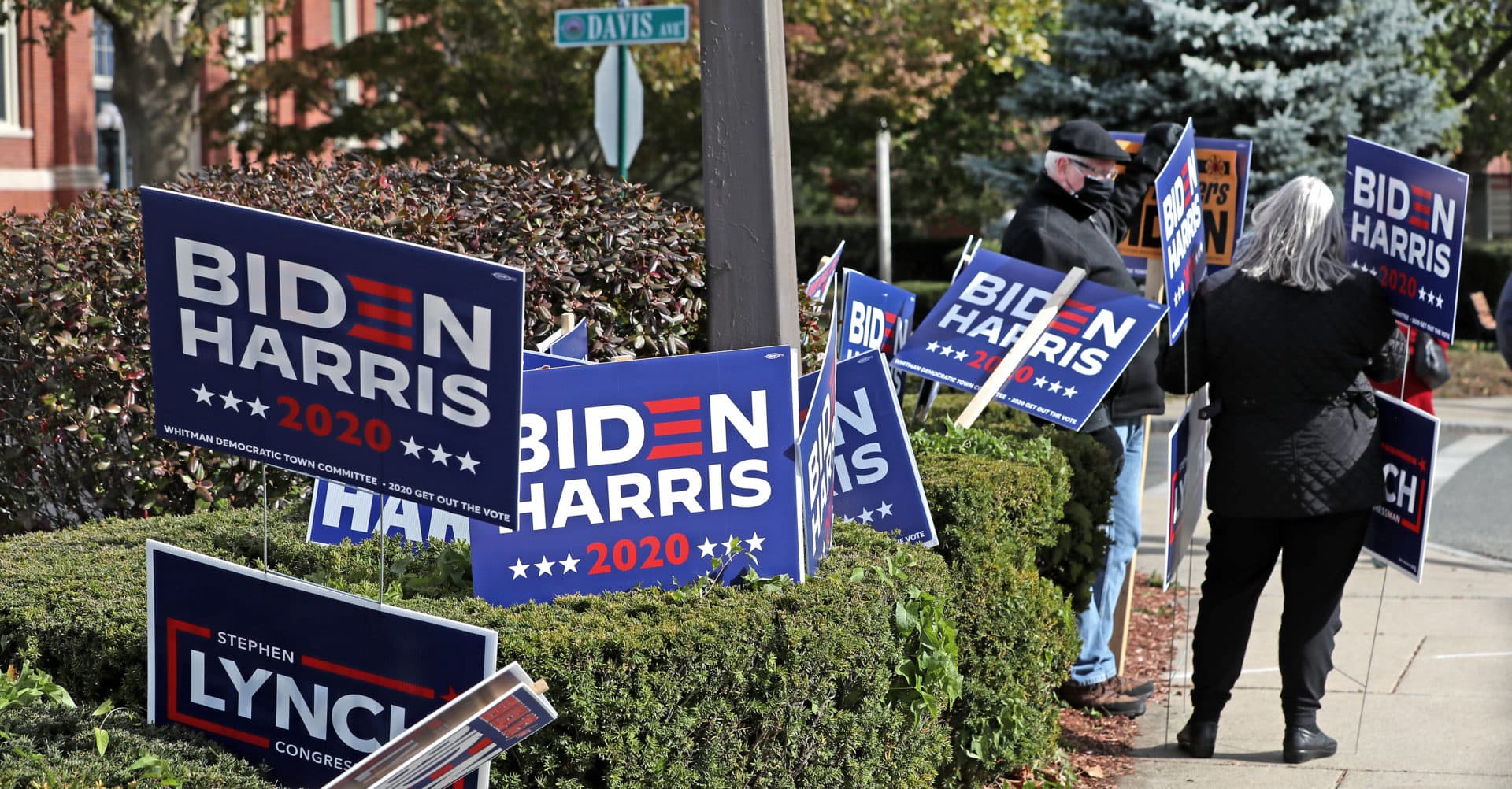 Voters hold signs in support of Biden-Harris outside Whitman Town Hall on Election Day.(David L. Ryan/The Boston Globe via Getty Images)