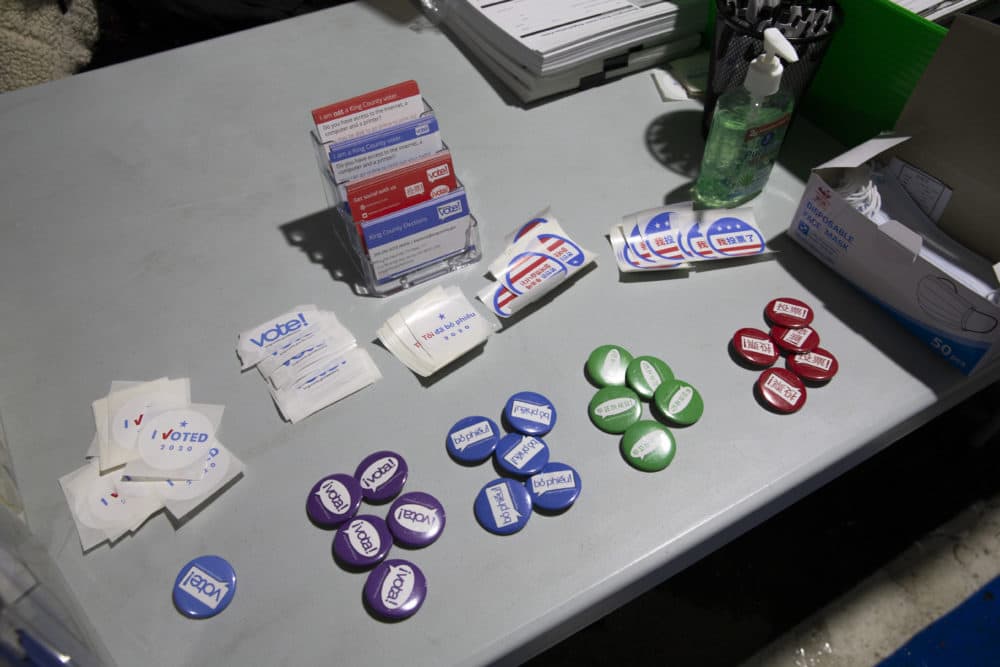 Buttons saying I voted in Spanish, Vietnamese, Korean and Mandarin are free to voters in the registration tent at the King County Elections headquarters voting center at on November 3, 2020 in Renton, Washington. These languages are the top most common languages in addition to English in King County, Washington. Washington state is on track to set a record for voter turnout this year. (Karen Ducey/Getty Images)