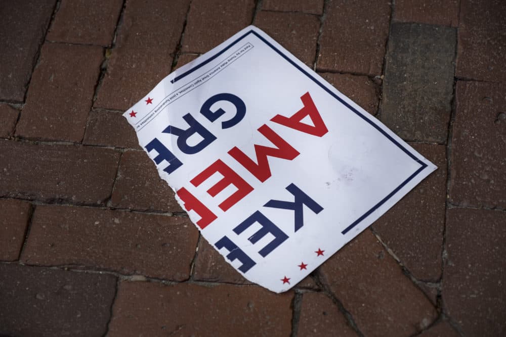 A torn poster on the ground outside the Massachusetts State House in Boston after skirmishes broke out during a demonstration by both Joe Biden and President Trump supporters on the day that the news broke that Biden was declared the winner of the U.S. presidential election Nov. 7, 2020. (Jodi Hilton/NurPhoto via Getty Images)