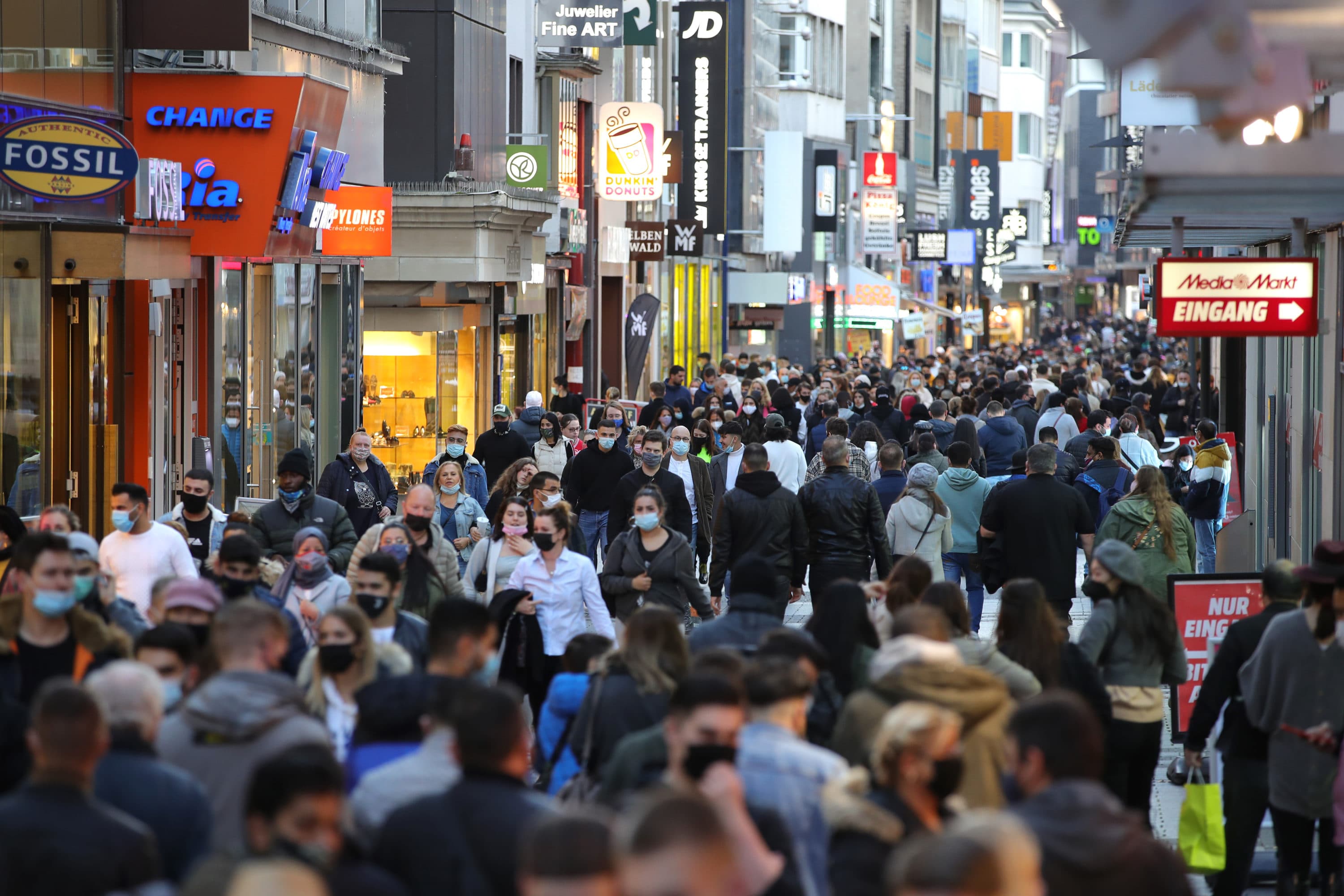 People wear protective face masks on the third day that local authorities mandated anew the wearing of masks outside in the city center during the second wave of the coronavirus pandemic on October 31, 2020 in Cologne, Germany. (Andreas Rentz/Getty Images)