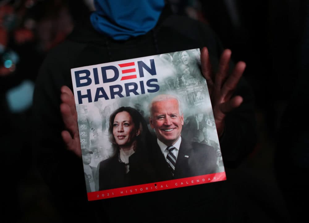 A supporter of President-elect Joe Biden shows a calendar with Biden and Vice President-elect Kamala Harris on cover outside the Chase Center where Biden addressed the nation November 07, 2020 in Wilmington, Delaware. (Joe Raedle/Getty Images)
