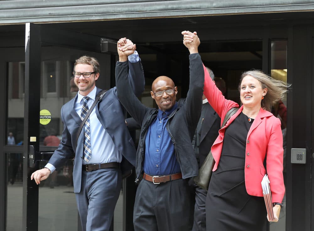 Frederick Clay, center, walks out of the Suffolk Superior Courthouse in Boston as a free man in August 2017. He is flanked by defense attorneys Jeffrey Harris and Lisa Kavanaugh. (Pat Greenhouse/The Boston Globe via Getty Images)