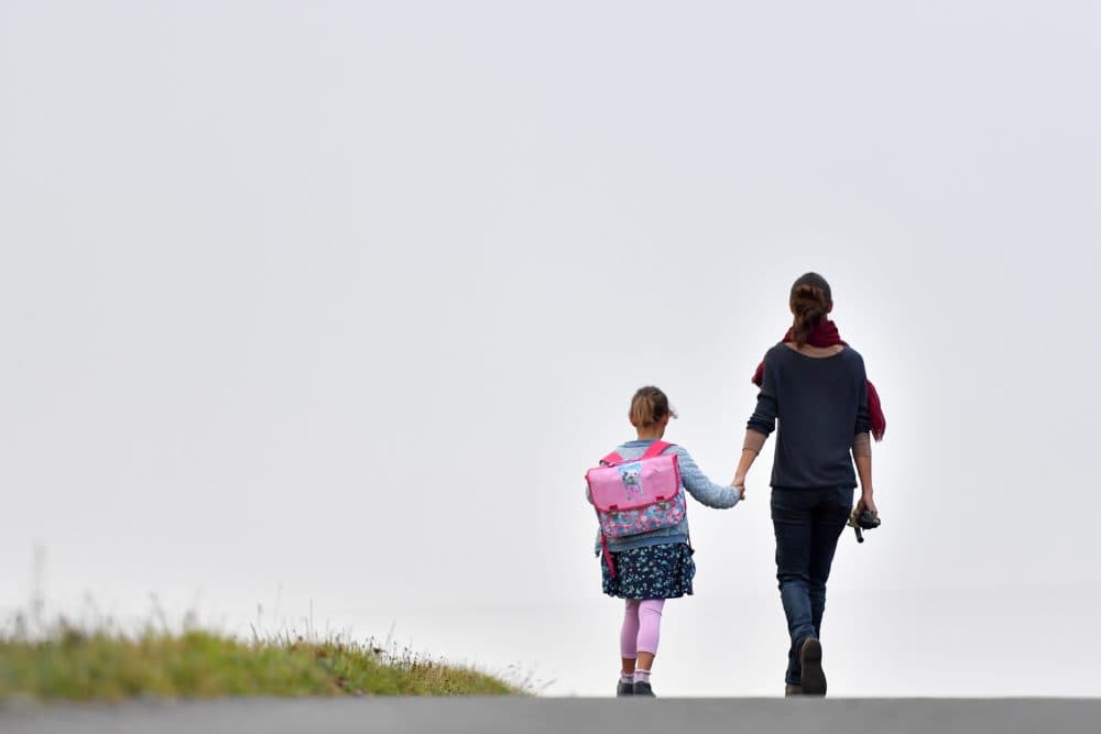 A girls walks to her primary school with her mother on the first day of the new school year in Vertou, western France, on Sept. 4, 2017. (Loic Venance/AFP Via Getty Images)