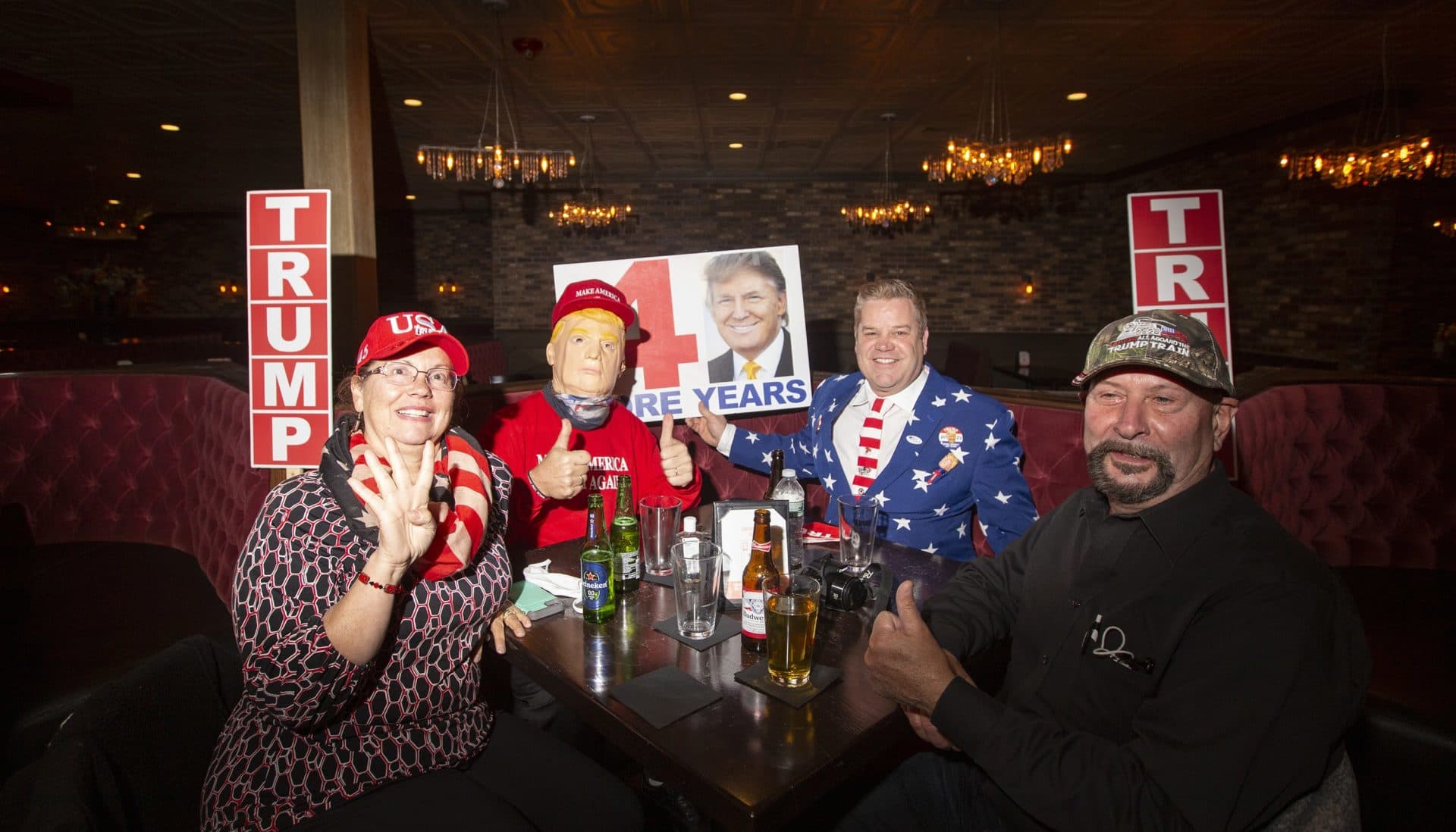 From left to right, Donna Forand, Jim Forand, both of Carver, Richard Desrosiers, of Fairhaven and Steven Miller, of New Bedford, at a watch party for President Donald Trump in Weymouth. (Joe Difazio for WBUR)