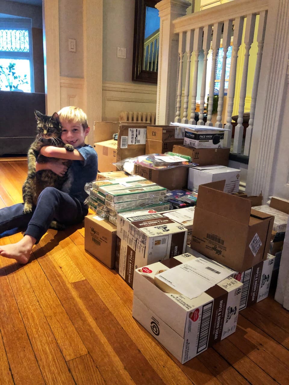 Nina Max Daly sent us this photo of the donations she's collected so far, alongside her son, Sid, and their cat. She writes, "We initially set out to create 40 care kits and 20 art kits which we plan to assemble on Thanksgiving day. However, we've had so much interest from friends, family and even some people we don’t know, that we’ve expanded to include food donations which will go to Pine Street Inn. The inspiration for this project came from my daughter, Rose, who over the summer -- and unprompted by us -- decided to spend her babysitting earnings to buy supplies and create care kits for guests of Pine Street Inn." (Courtesy)