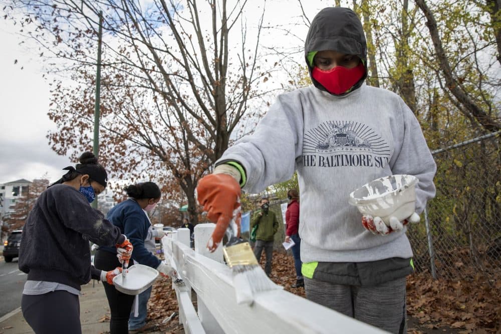 Abrar Hoque and other teens help clean up the area near Jerry's Pond. (Robin Lubbock/WBUR)