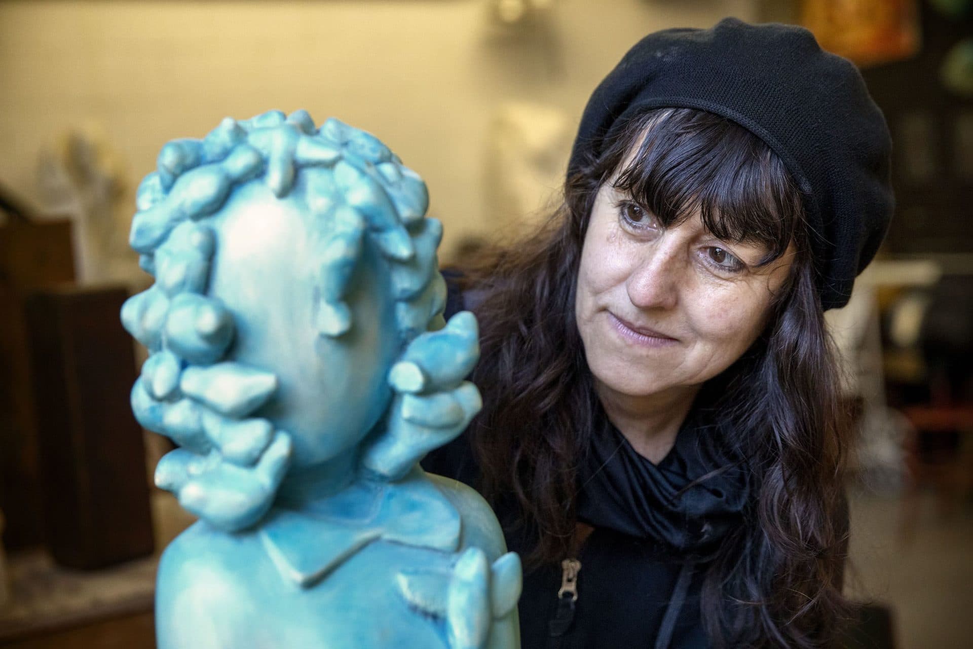 Sculptor Nora Valdez with &quot;Singing Birds&quot; at her workshop at Humphreys Street Studios in Dorchester, Mass. (Robin Lubbock/WBUR)