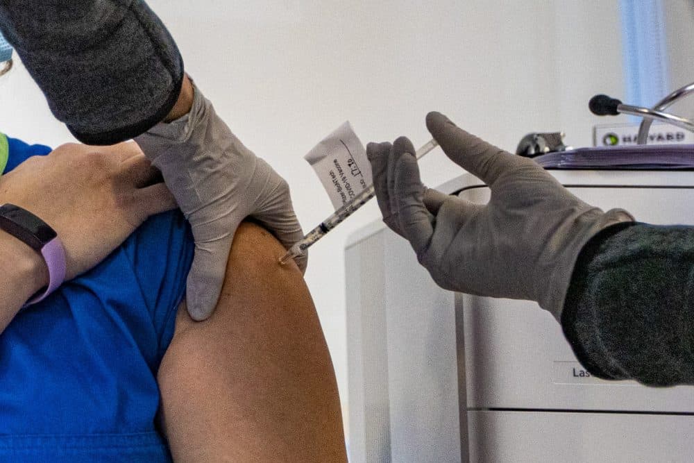 Pfizer's COVID-19 vaccination is administered to a Tufts Medical Center employee on Dec. 15. (Jesse Costa/WBUR)