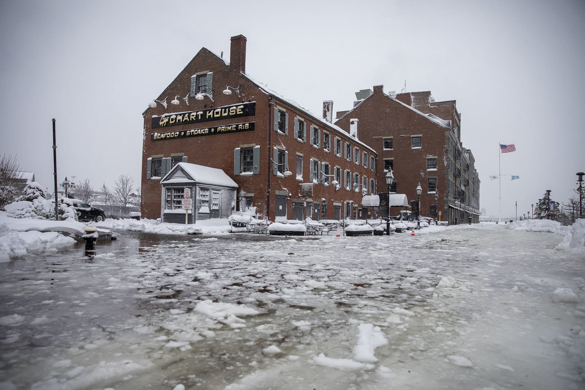 At high tide during the snow storm sea water floods across Long Wharf by the Chart House. (Robin Lubbock/WBUR)