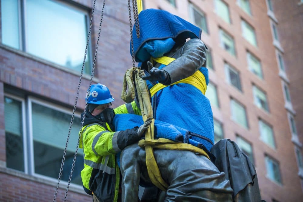 A worker ties up the 2,800 lb. statue to prepare it for removal from its pedestal in Park Square. (Jesse Costa/WBUR)