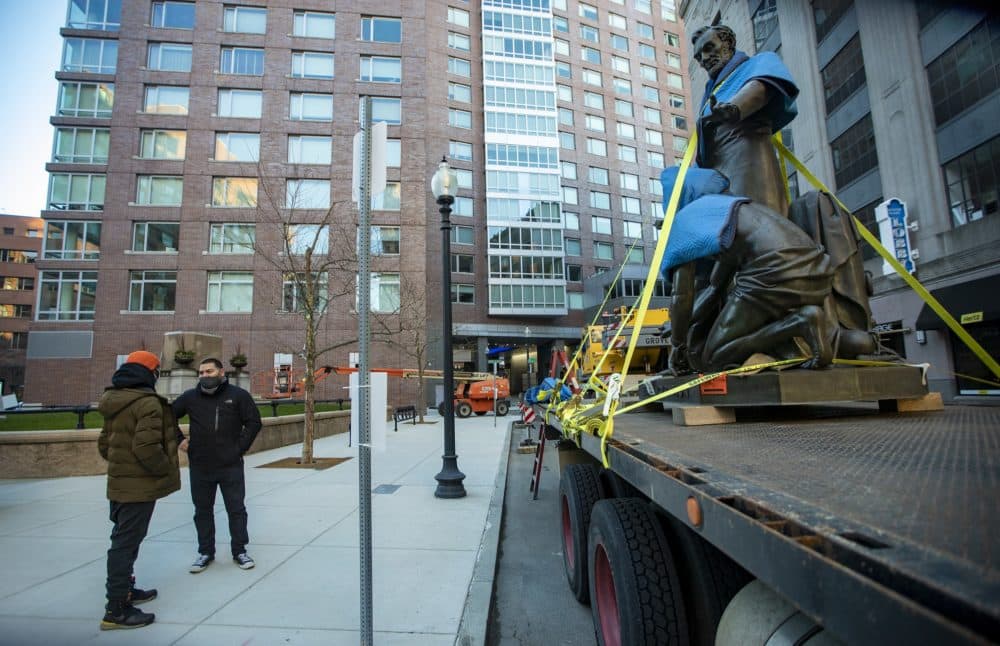 Raul Fernandez, right, and Tory Bullock discuss the removal of &quot;Emancipation Group&quot; after it was removed from its pedestal in Park Square Tuesday morning. (Jesse Costa/WBUR)