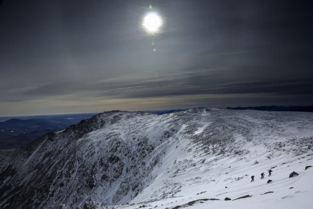 Under a midday winter solstice sun, a trio of climbers make their way up a slope on Mount Washington, Saturday, Dec. 21, 2019, in New Hampshire. (Robert F. Bukaty/AP)