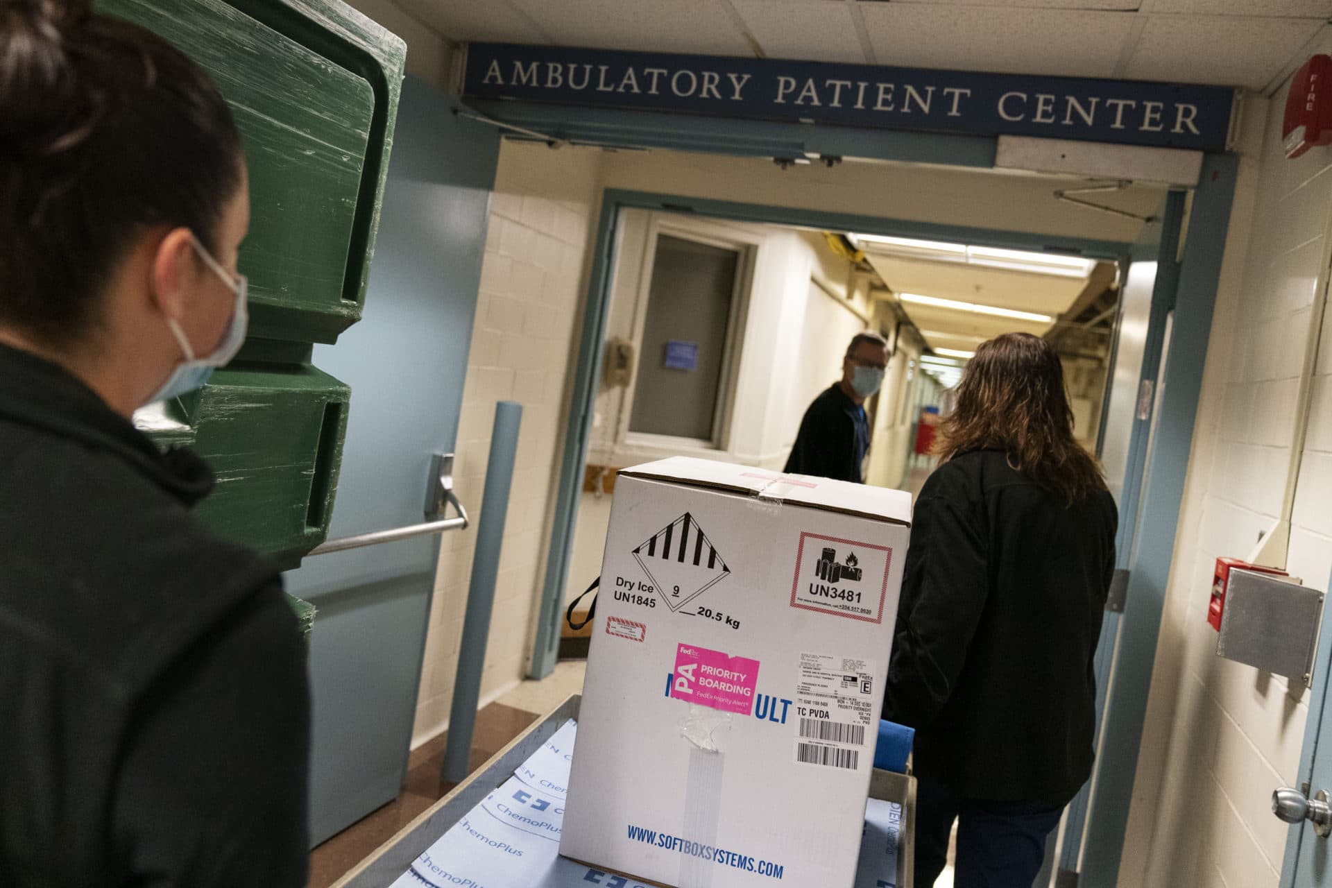 Pharmacists wheel a box containing the Pfizer-BioNTech COVID-19 vaccine to a freezer as it arrives at Rhode Island Hospital in Providence, R.I, Monday, Dec. 14, 2020. (David Goldman/AP)