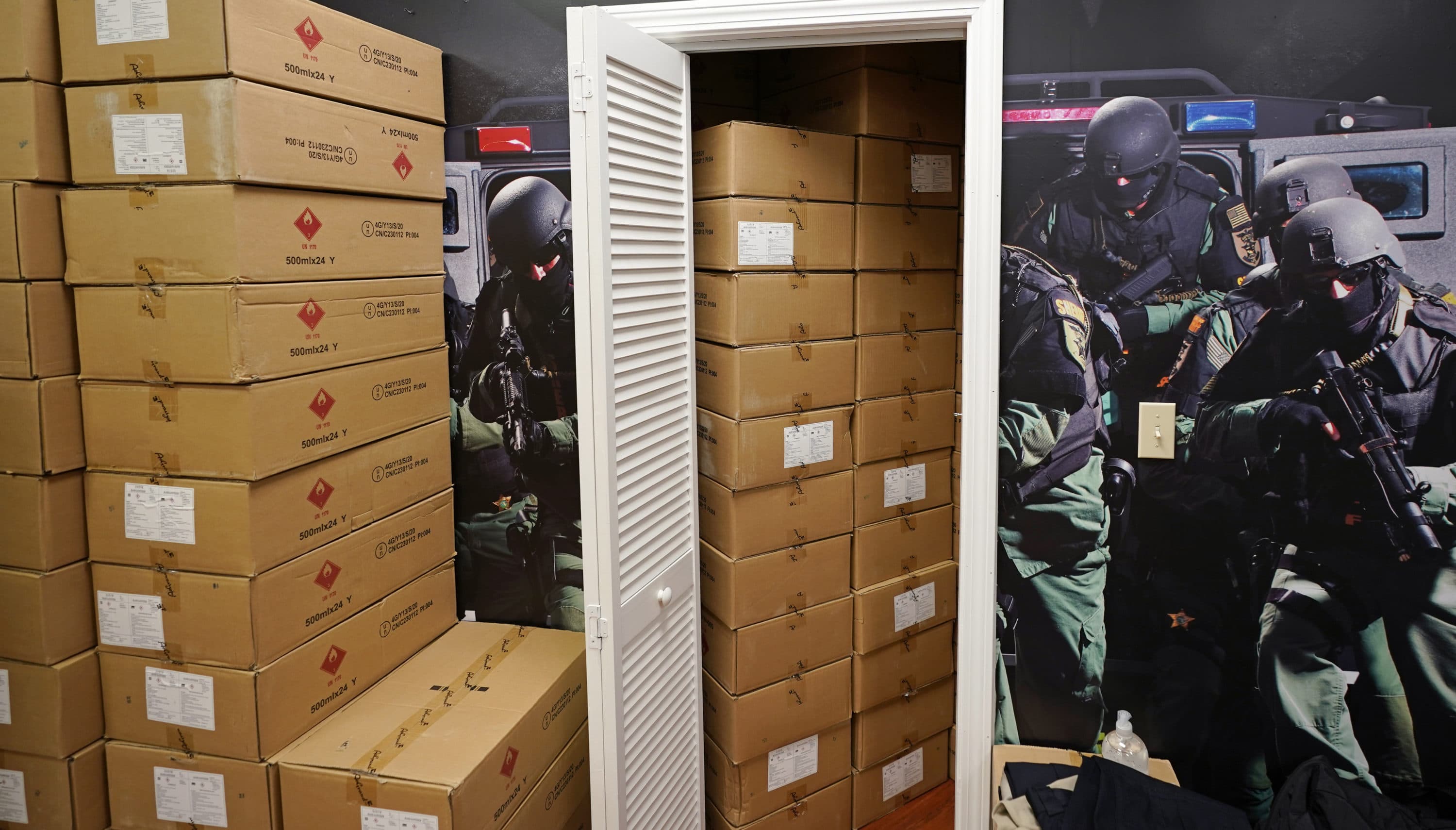 Cases of hand sanitizer are stacked on the retail floor and stored in a changing room for fitting bulletproof vests at the Body Armor Outlet store, Wednesday, Dec. 9, 2020, in Salem, N.H. (Charles Krupa/AP)