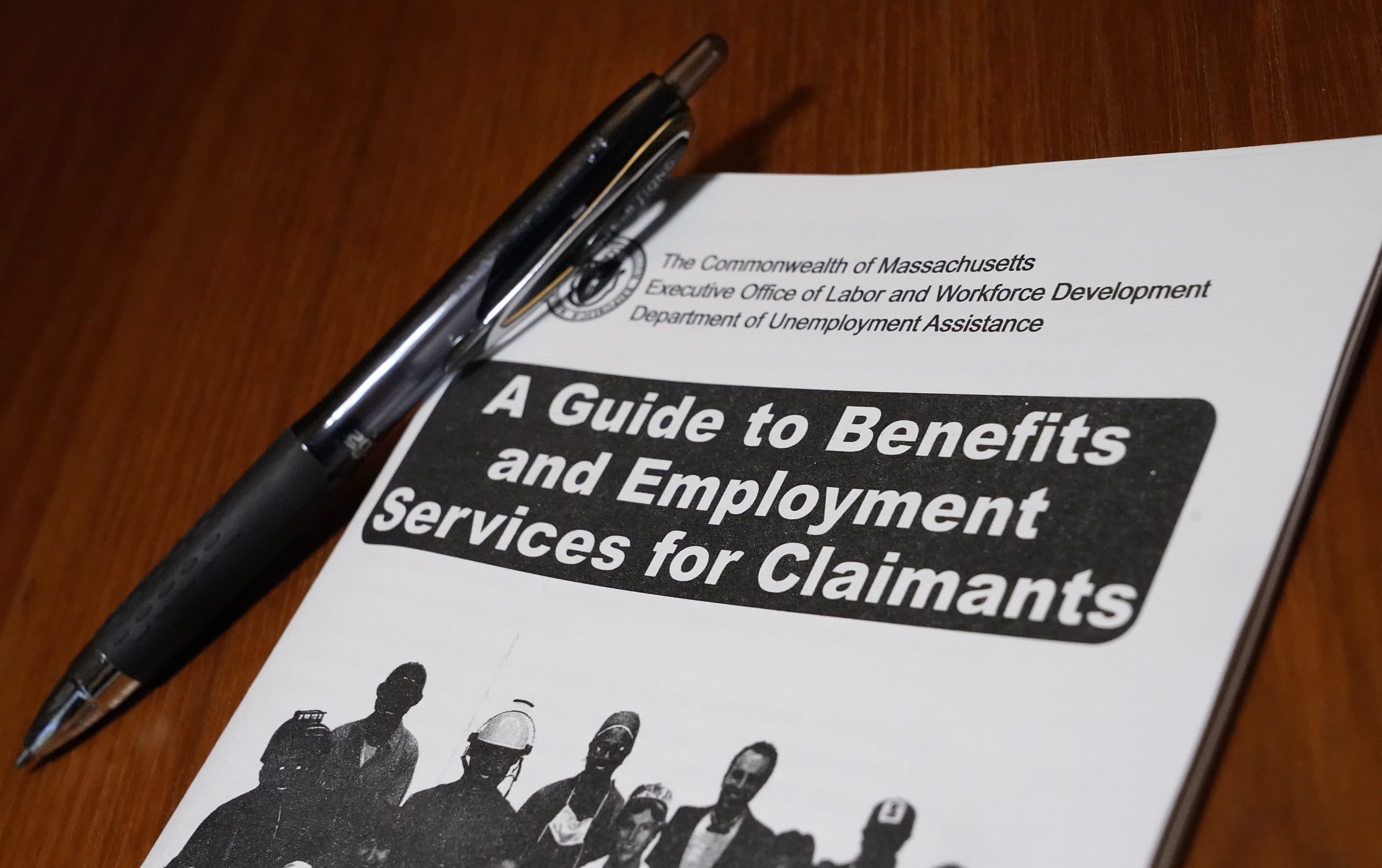 A booklet describing unemployment benefits is seen on a desk in North Andover, MA. (Elise Amendola/AP)