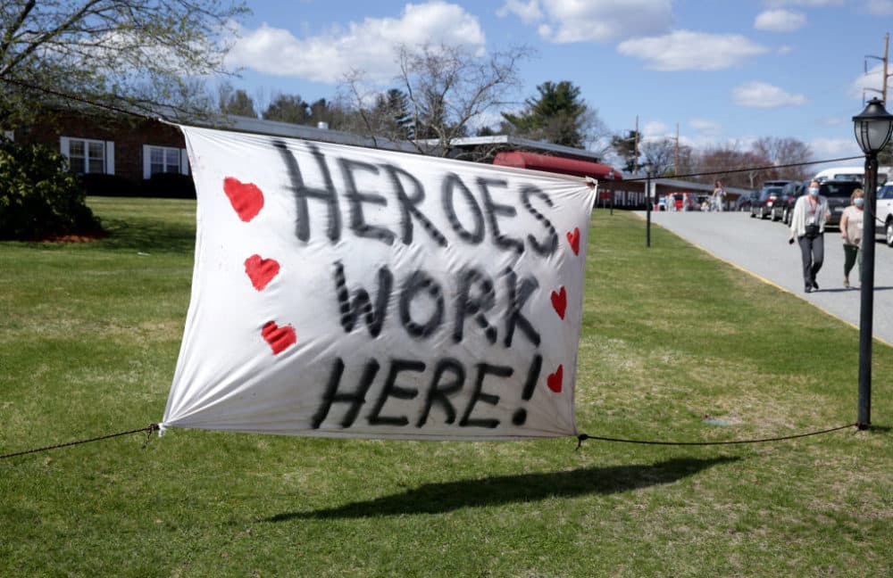 A sign thanks Members of the Massachusetts National Guard, reading "Heroes Work Here," as they are deployed to the Palm Center nursing home facility to aide in testing at the facility in Chelmsford, MA on Apr. 7, 2020. (Jonathan Wiggs/The Boston Globe via Getty Images)