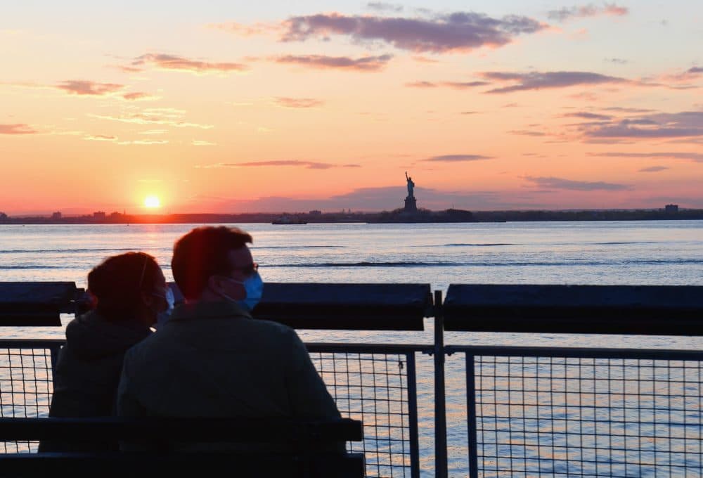 A couple watches the sunset on April 28, 2020 in New York City. (Angela Weiss/AFP via Getty Images)