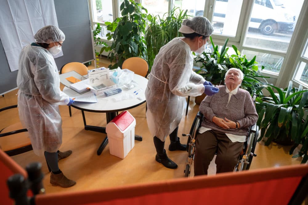 A geriatric nurse carries out a rapid antigen corona test in the Pauline Krone Home for the Elderly of the Tübingen elderly care centre in Baden-Wuerttemberg, Tübingen, Germany. (Sebastian Gollnow/Picture Alliance via Getty Images)