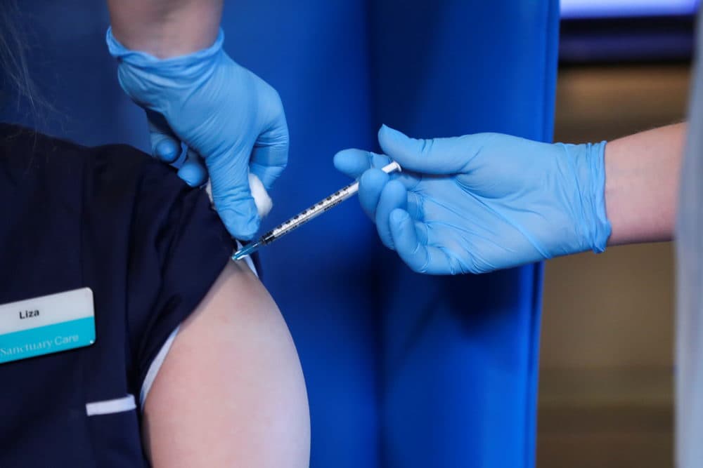 A patient receives the Pfizer/BioNTech vaccine in Dec. 2020. (Russell Cheyne/WPA Pool/Getty Images)