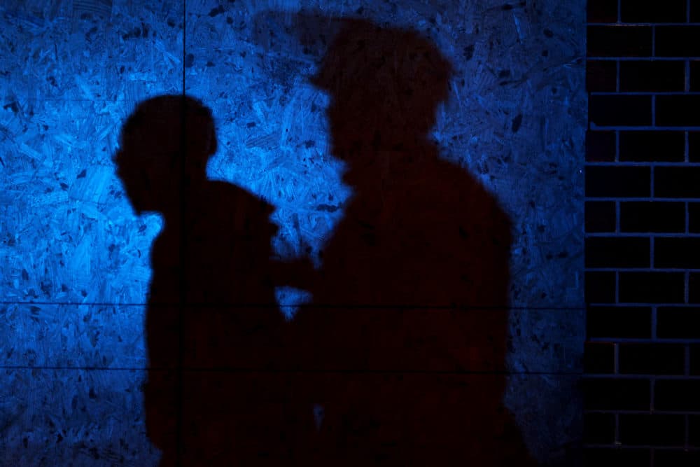 The shadow of a Louisville Police officers arresting a demonstrator is seen on a wall on Sept. 23, 2020 in Louisville, Kentucky. (Michael M. Santiago/Getty Images)