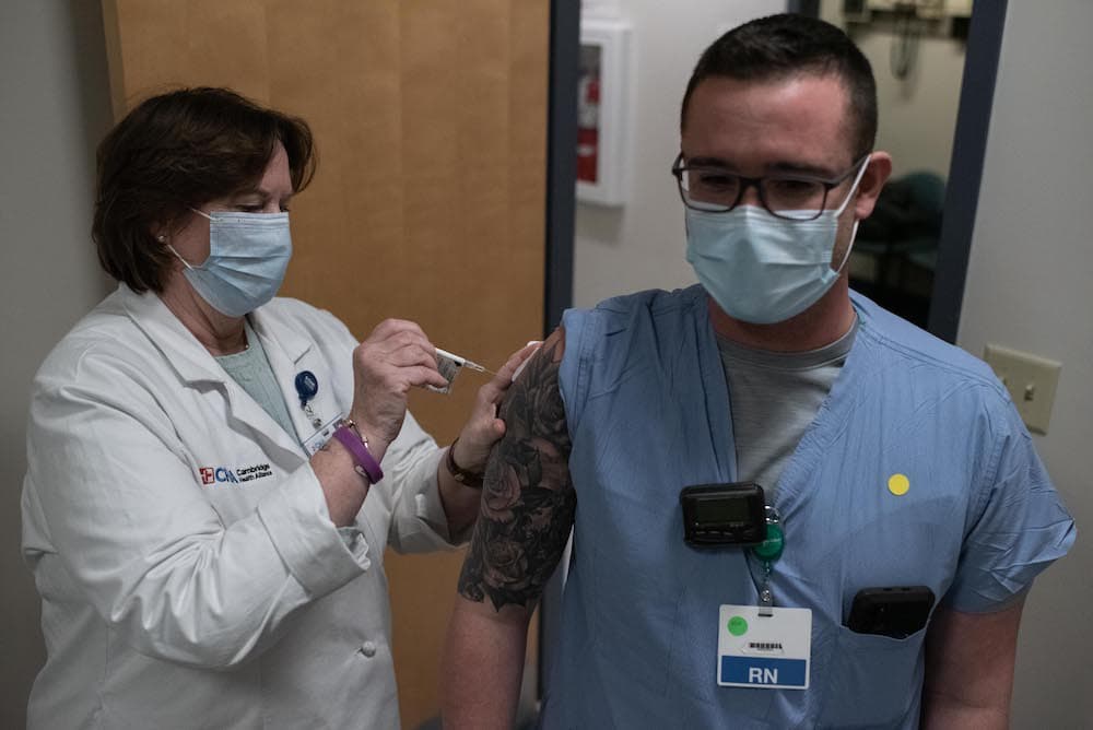 RN Erik Westhaver gets his coronavirus vaccine at the Cambridge Health Alliance COVID-19 clinic in Somerville, Mass. (Photo courtesy Dr. Anna Rabkina)