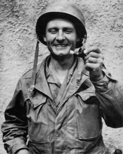 Father Emil Kapaun holding a pipe. (Courtesy)