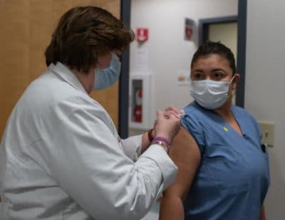 RN Jane E. Buley administers a coronavirus vaccine at the Cambridge Health Alliance clinic in Somerville. (Courtesy Dr. Anna Rabkina)