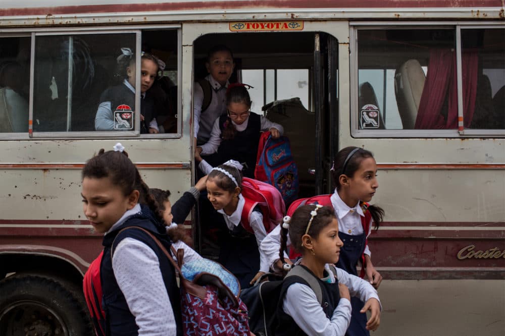Western Mosul, Iraq, November 2018. Schoolgirls arrive at a recently reopened school. For many students, this is the first time they have been able to attend school in years. (Nicole Tung)