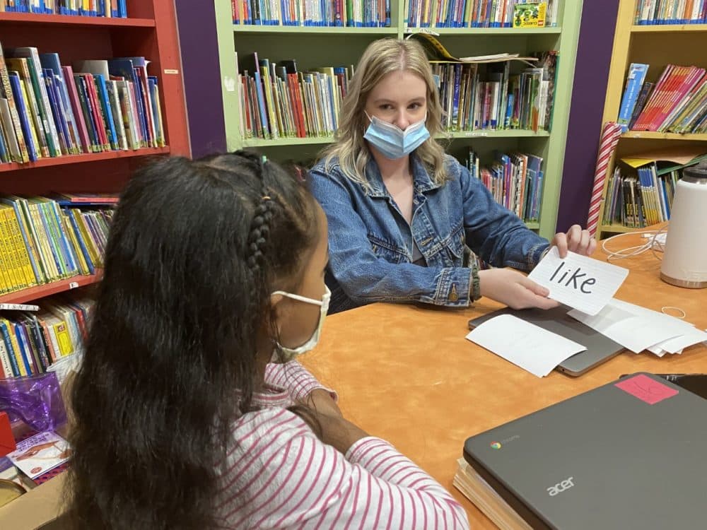 Boys & Girls Club of Worcester education coordinator Olivia Hamilton assists a student with remote learning. (Courtesy)