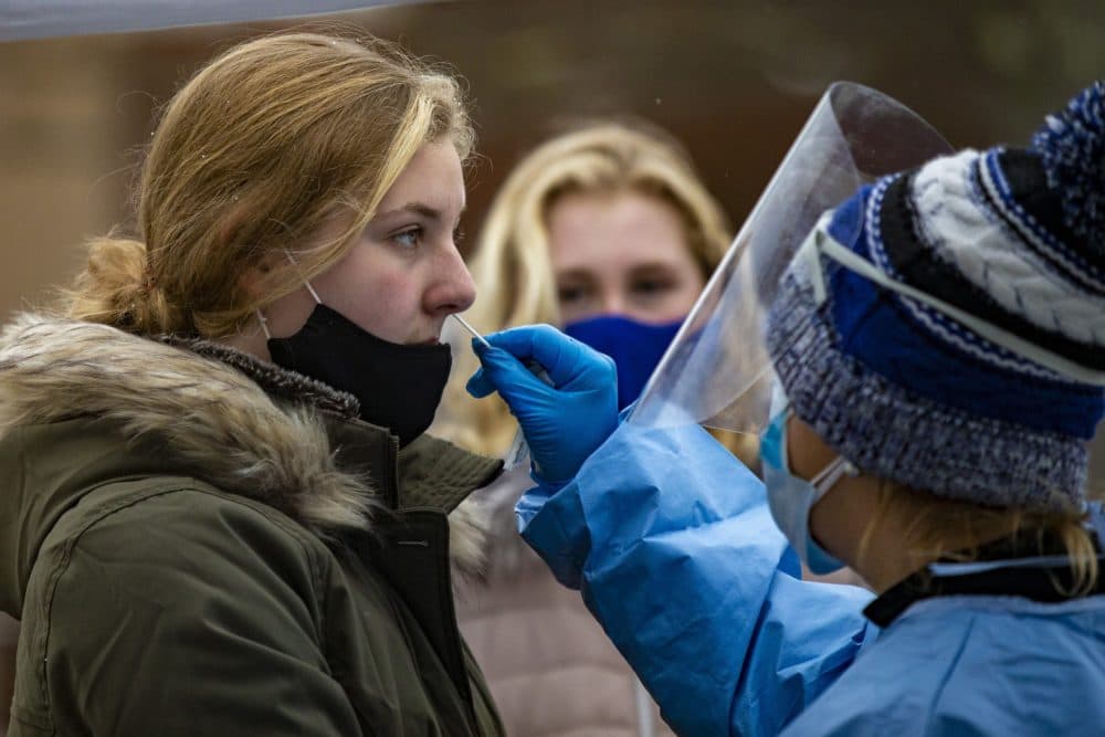 Molly Squire, 16, and her younger sister Emma, 13, live close by, so they walked to the high school to receive COVID-19 testing at the Bromfield School in Harvard, MA. (Jesse Costa/WBUR)