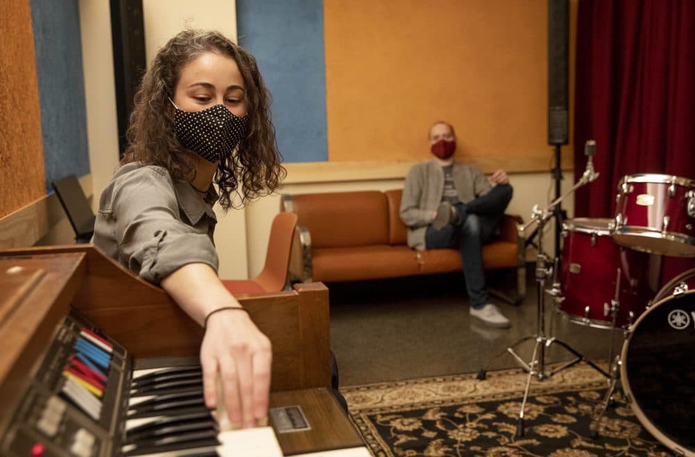 The Record Co. community manager Maria Bartolotta plays a few notes on an organ in one of the new practice studios. (Robin Lubbock/WBUR)