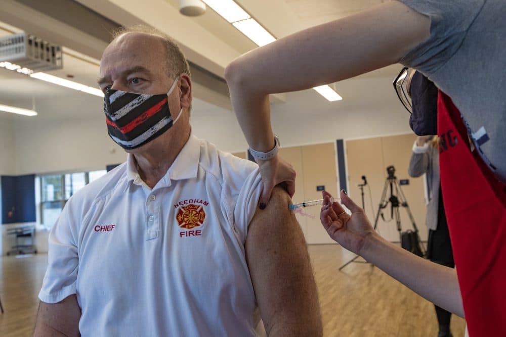 Needham Fire Chief Dennis Condon receives the Moderna COVID-19 vaccine at Rosemary Recreational Center in Needham. (Jesse Costa/WBUR)